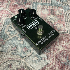 MXR carbon copy analog delay guitar effects pedal on a patterned surface