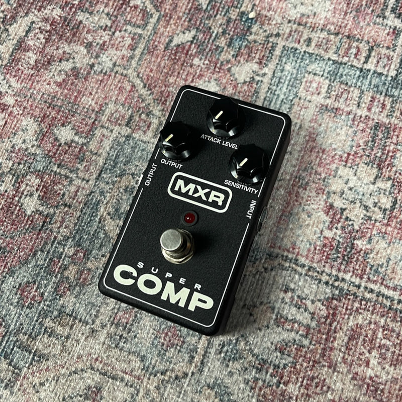 MXR Super Comp guitar effects pedal on a textured surface