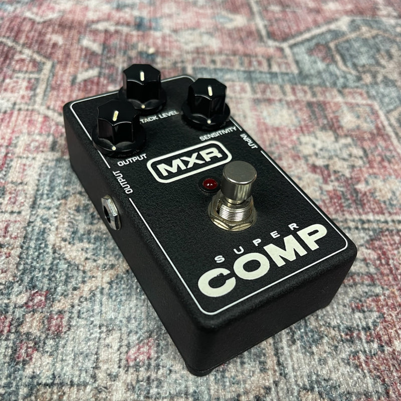 MXR Super Comp guitar effects pedal on a textured surface