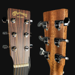 Close-up of Martin guitar heads with brand logo on a black background