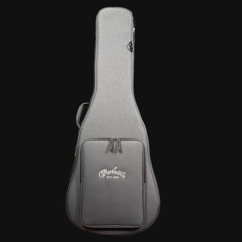 Gray guitar case with Martin logo on a black background