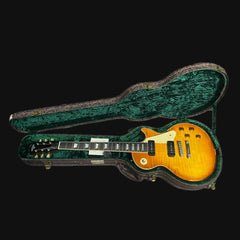 Electric guitar in a green case on a black background