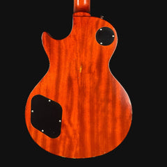 Back view of a wooden electric guitar with a dark brown finish on a black background