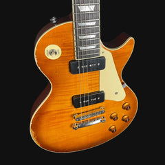 Electric guitar with a sunburst finish on a black background