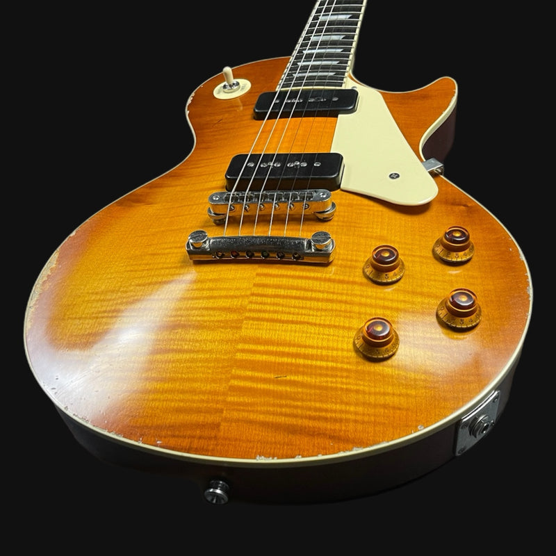 Electric guitar with a sunburst finish on a black background