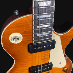 Close-up of a guitar with a focus on the neck and body.