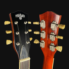 Close-up of two guitar heads with Maybach branding on a black background