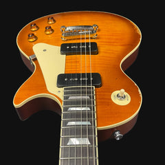 Electric guitar with a sunburst finish on a black background
