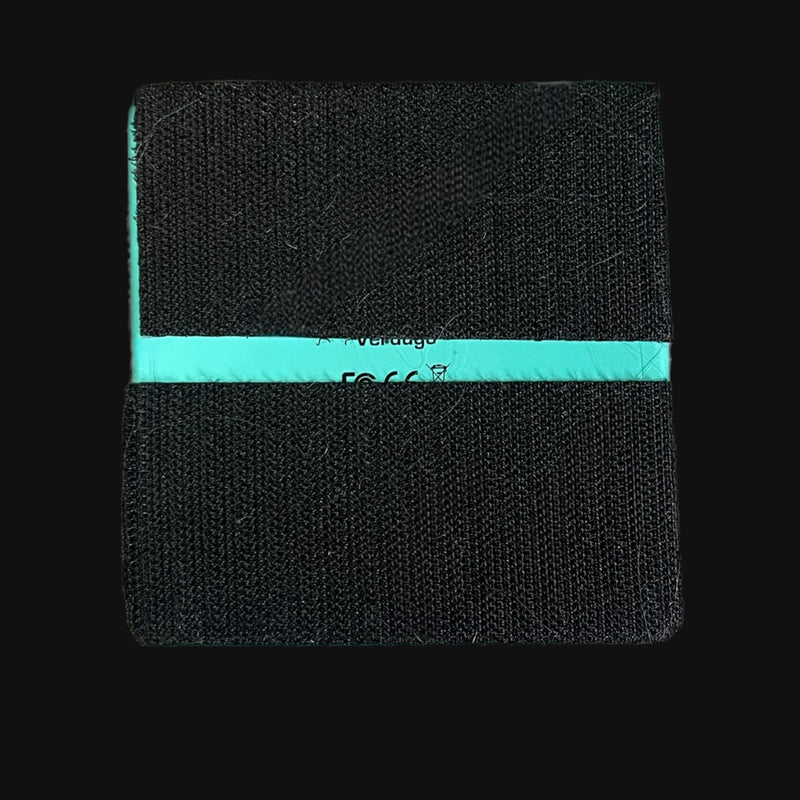 Black wristband with a turquoise stripe on a black background