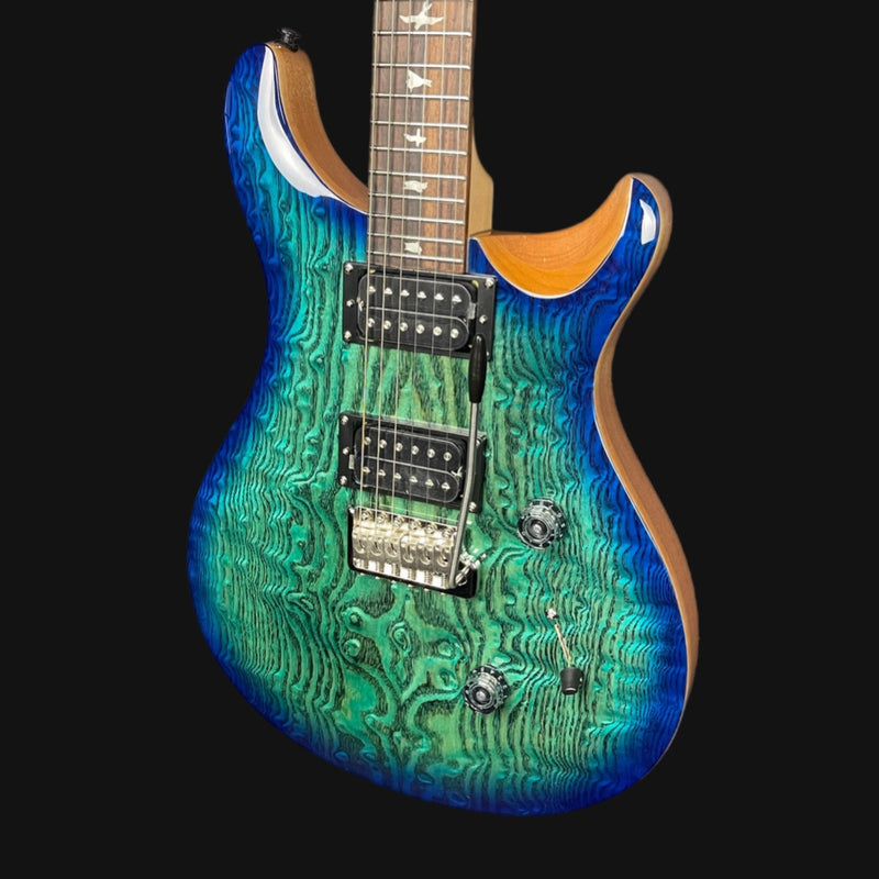 Blue electric guitar with a wavy pattern on a black background