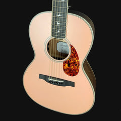 Acoustic guitar with a flame maple top on a black background