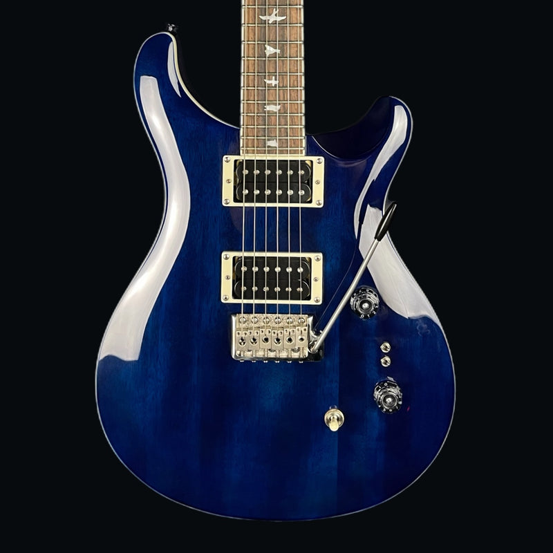 Blue electric guitar with a glossy finish on a black background