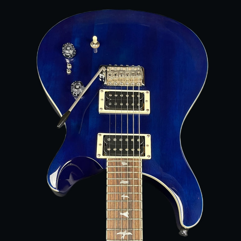 Blue electric guitar with a clear case on a black background