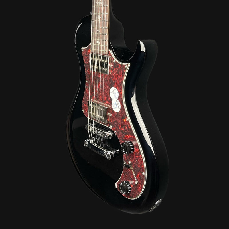 Black electric guitar with red flame pattern on a black background