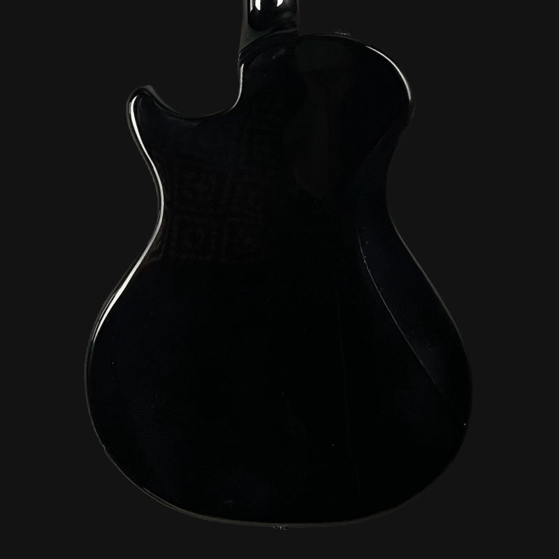 Silhouette of a black electric guitar on a black background