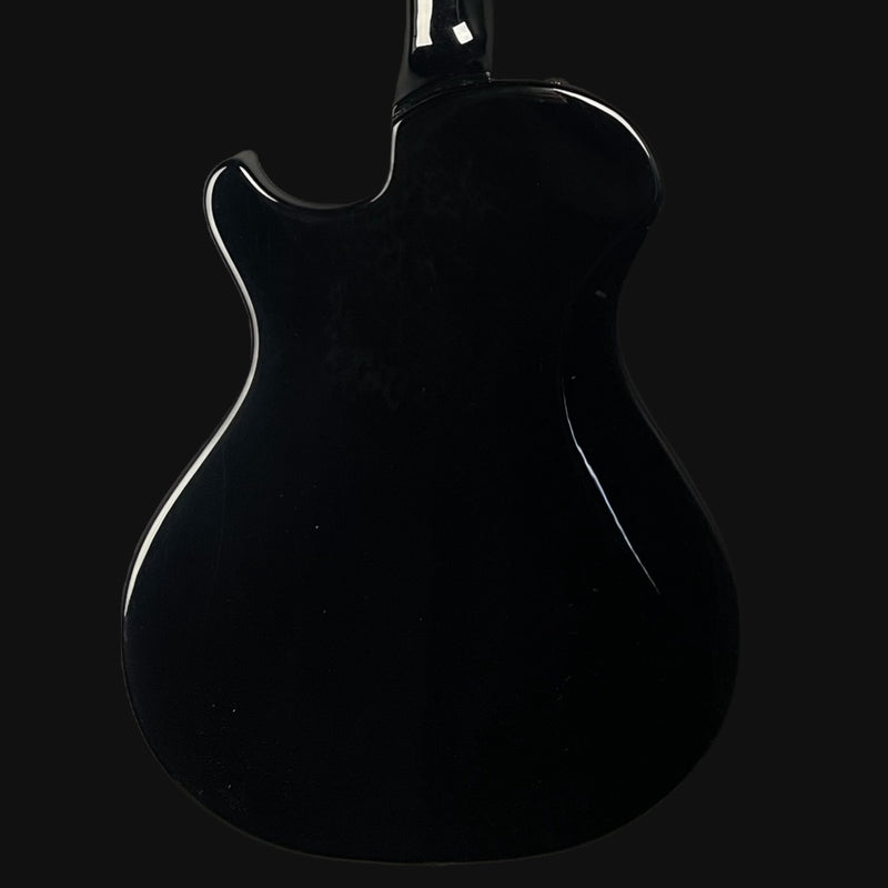Black electric guitar on a black background