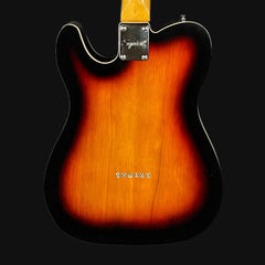 Guitar body with a sunburst finish on a black background