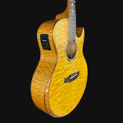 Acoustic guitar with a quilted top on a black background