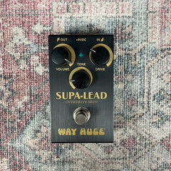 Guitar effects pedal labeled 'Supa-Lead' on a textured surface