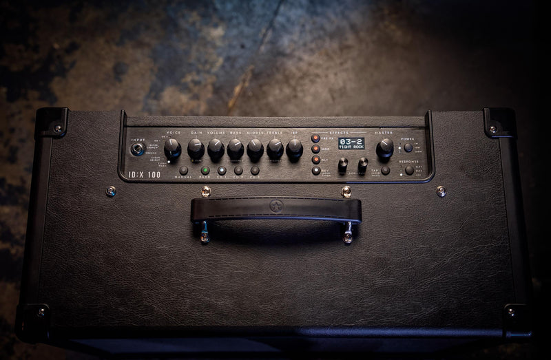 Guitar amplifier with control panel on a textured surface