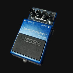 Boss compressor pedal on a black background