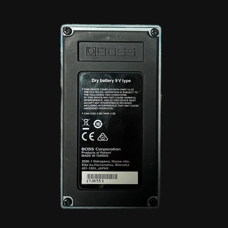 Back view of a BOSS device with label and branding on a black background