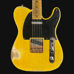 Yellow electric guitar with a black pickguard on a black background