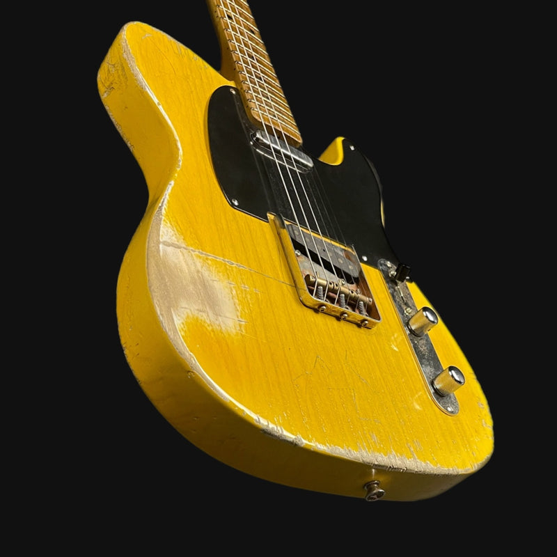 Yellow electric guitar on a black background