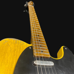 Close-up of a guitar with a black and yellow design on a black background